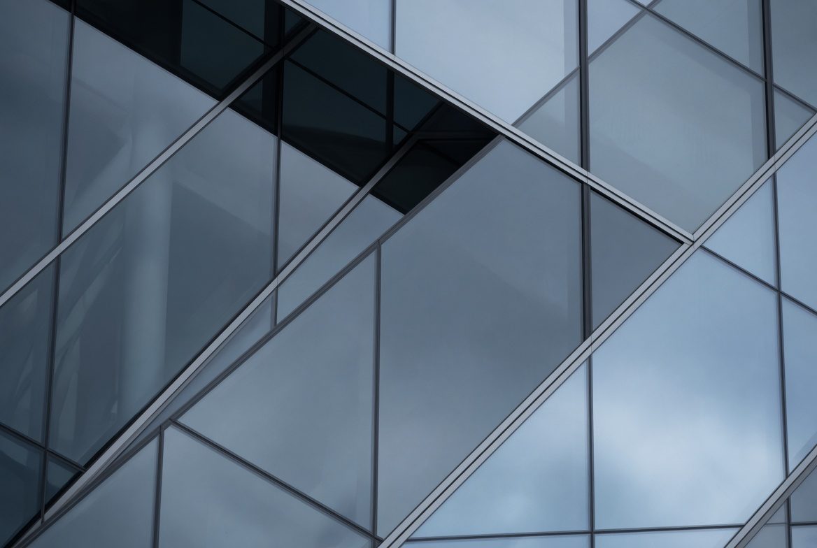 Glass office building facade, representing protective security